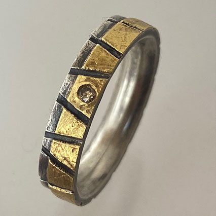 Twotone Ring with alternating stripes and flush set diamond