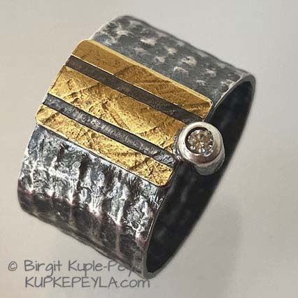wide band with 3 gold stripes and diamond